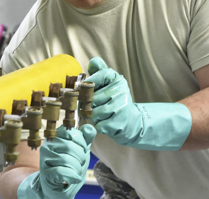 spray nozzle technician adjusting nozzle system