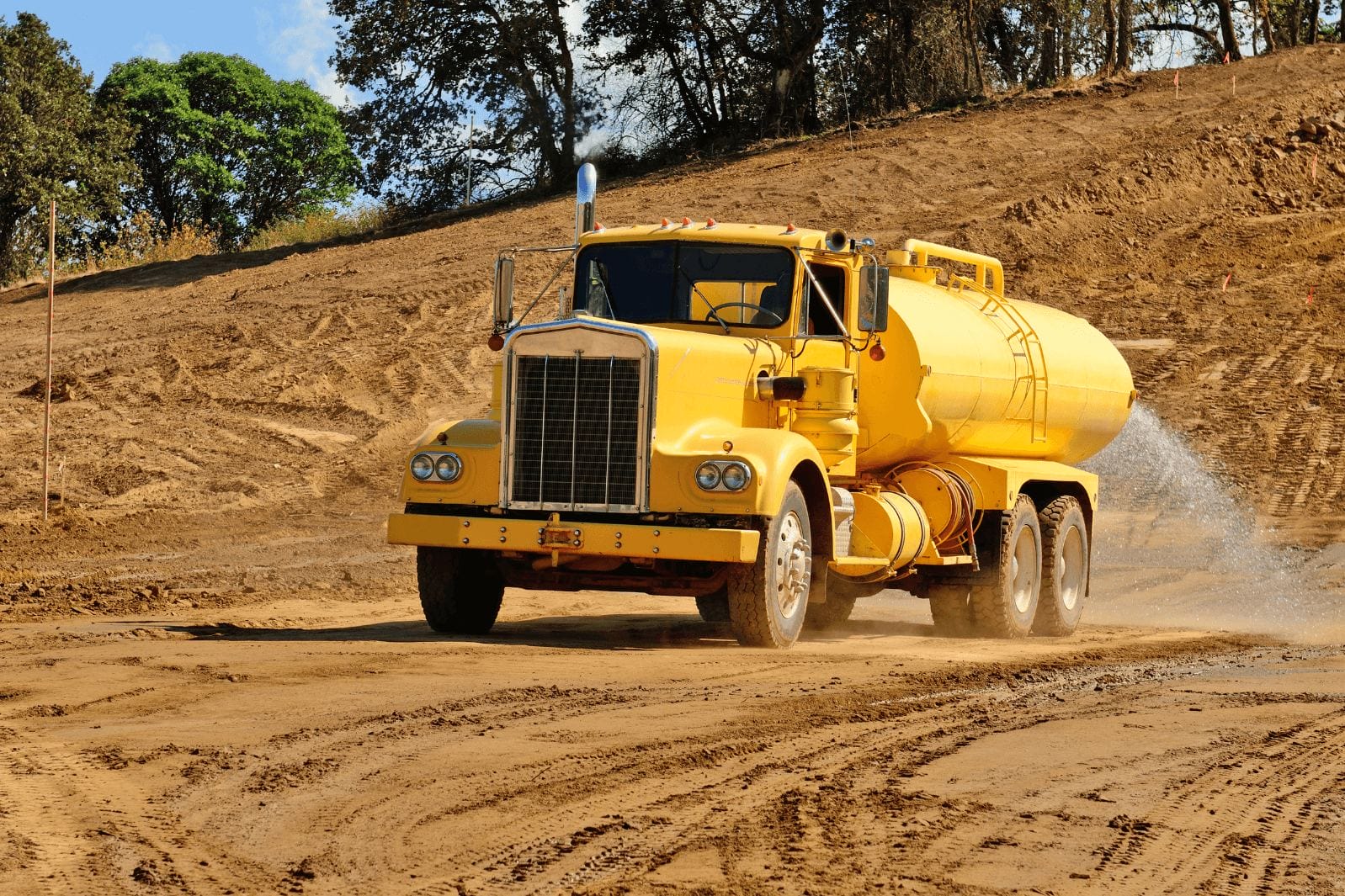 truck spraying water over mining site suppression dust 