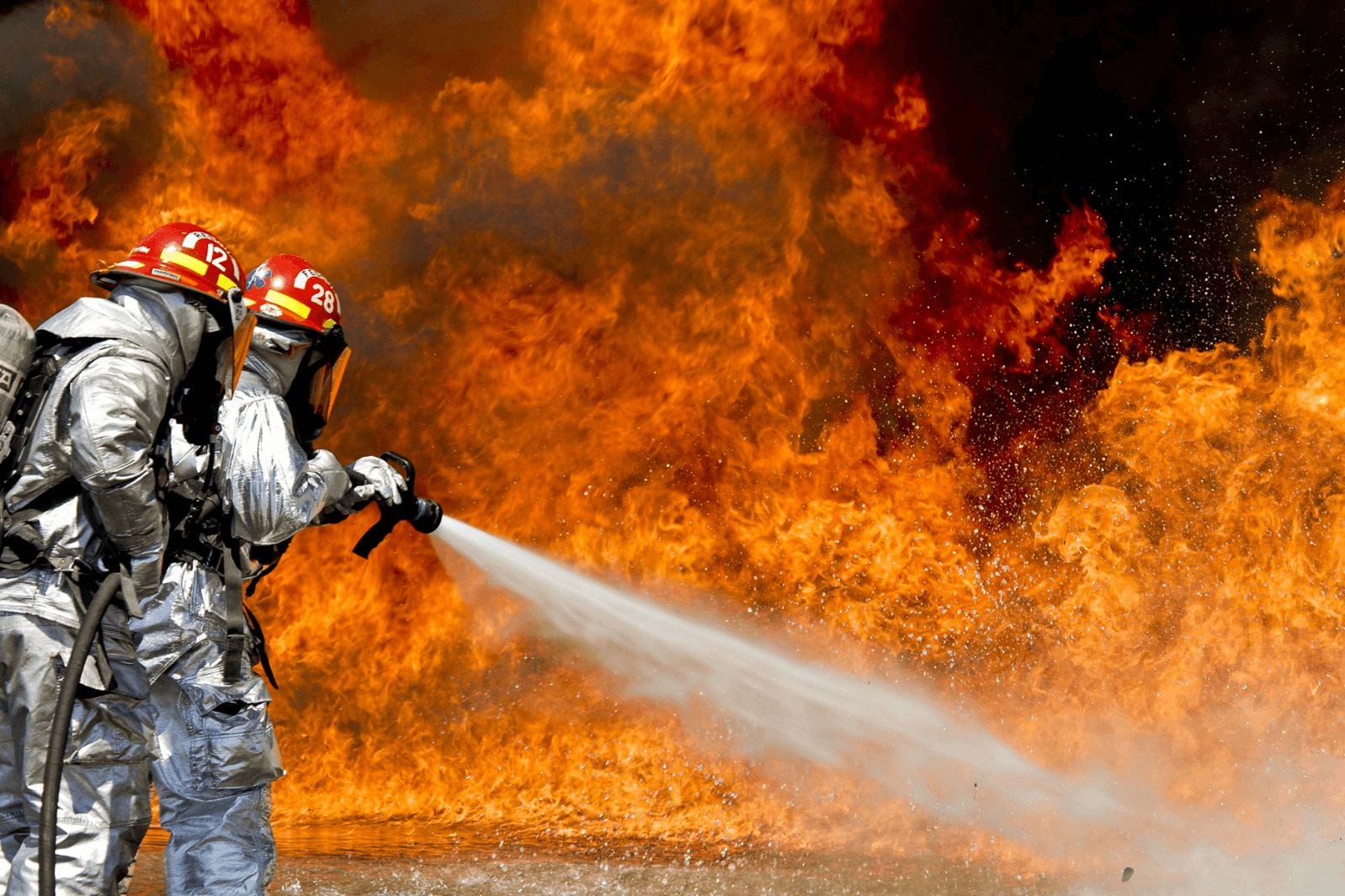 fire fighter with adjustable hand nozzle spraying water